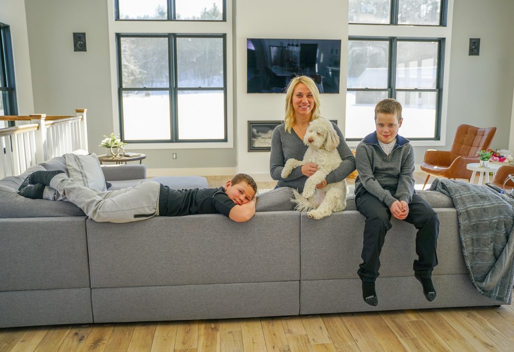 Alexa Plus - family posing in a living room with a dog